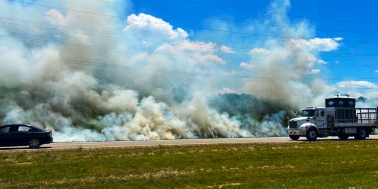 PHOTOS: 300-ft. ditch fire burns on West Andrew Johnson Highway amid dry conditions