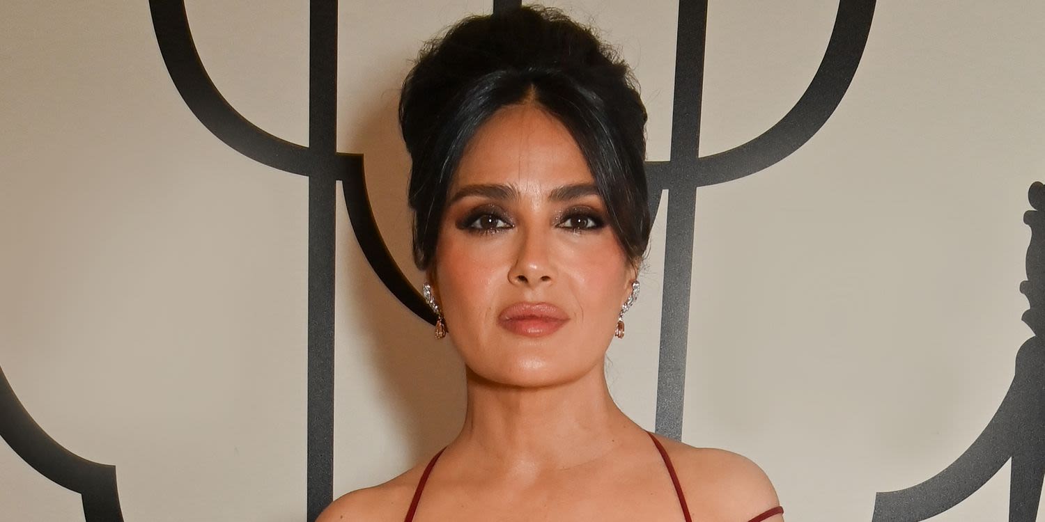 Salma Hayek Layered Sheer Snakeskin Cover-Up Over a Plunging One-Piece