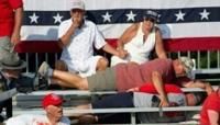 Trump supporters are seen covered with blood in the stands after guns were fired at Republican candidate Donald Trump at a campaign event