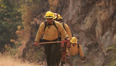 Heavy gear, unforgiving terrain, backbreaking work. Now firefighters contend with extreme heat too