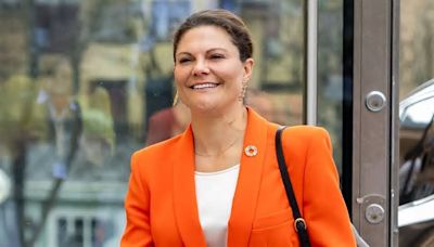 Crown Princess Victoria of Sweden stuns in a striking orange trouser suit at the Global Sustainable Tourism Conference