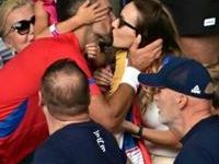 Golden Slam: Novak Djokovic gives his wife Jelena a kiss as he celebrates with his family after beating Carlos Alcaraz in the men's tennis final