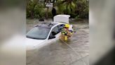 WATCH: Florida firefighters rescue woman from flooded car