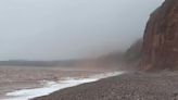 Dramatic photos show cliff collapsing as Devon is battered by rain