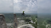 Rider Launches Off Towering Cliff With Parachute