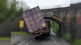 HGV lorry lodged underneath bridge following crash