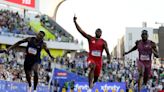 Lyles wins 100-meter gold in quest for sprint double
