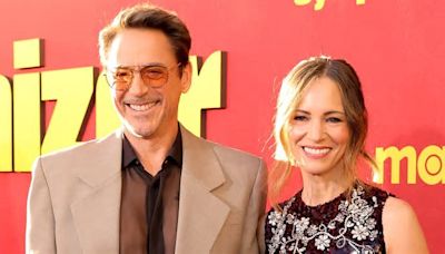 Robert Downey Jr. beams alongside wife Susan as he joins his co-star Sandra Oh at the premiere for their HBO series The Sympathizer in LA