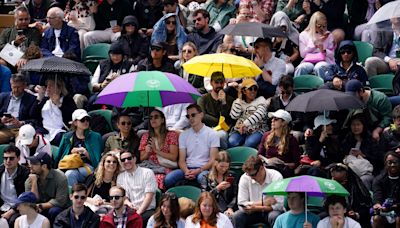 Heavy downpours suspend play on outdoor courts at Wimbledon