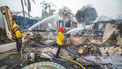 Wildfires plague the West amid a scorching heat wave. Homes burn in Southern California