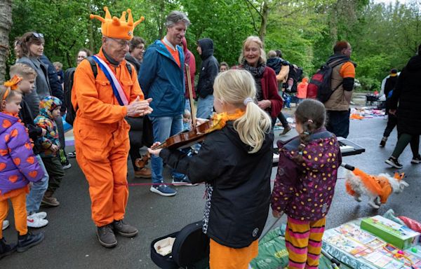 Orange crush: Boats packed with revelers tour Amsterdam canals to celebrate the king’s birthday