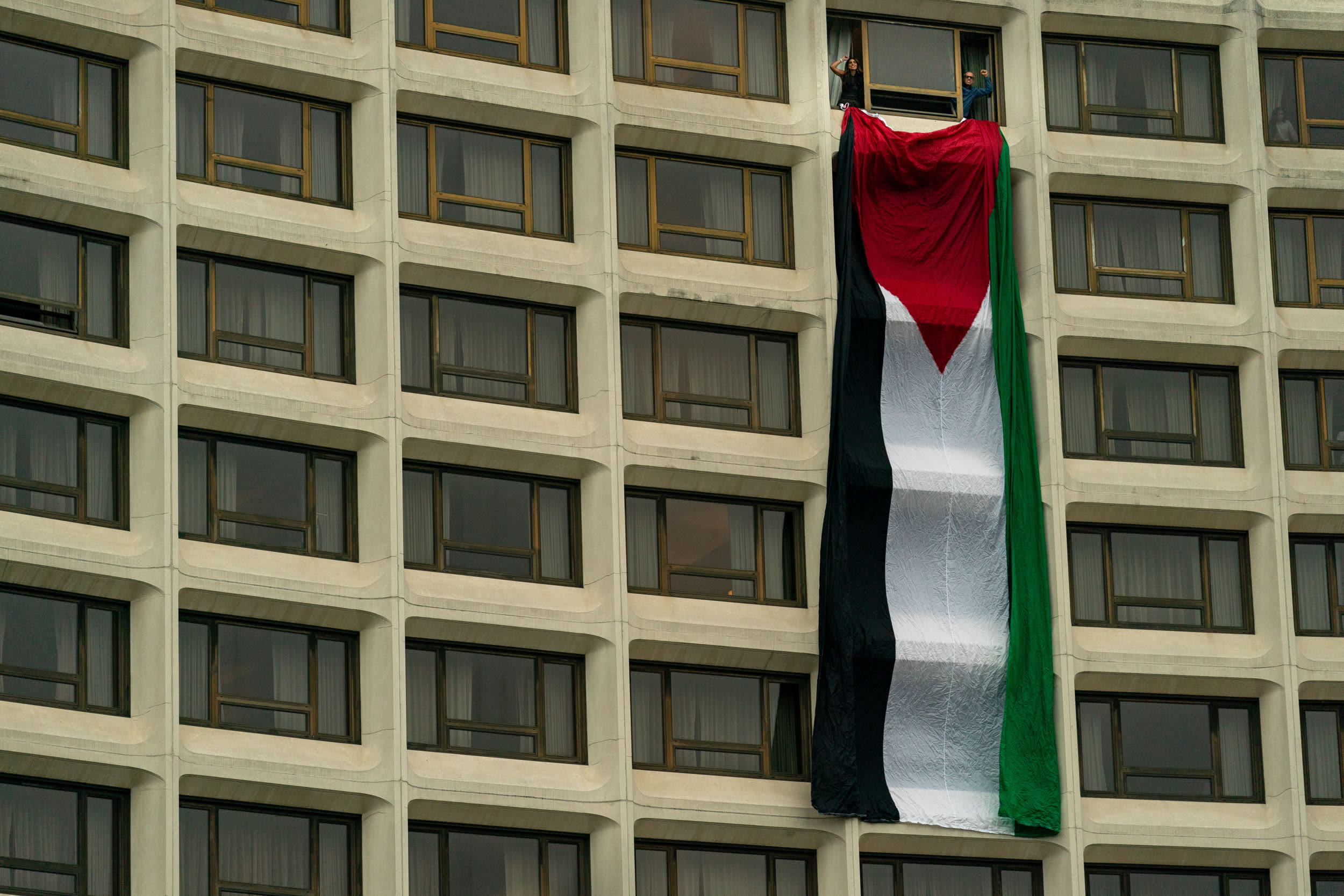 Protesters hang Palestinian flag from venue before Joe Biden's speech