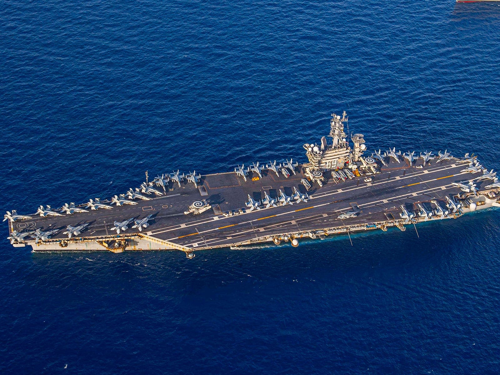 The US Navy carrier strike group fighting off Houthi missiles is staying in the Red Sea for now