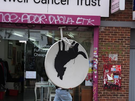 Banksy’s howling wolf artwork removed less than an hour after unveiling