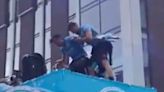 Jack Grealish almost falls off Manchester City’s open-top bus parade twice