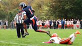 Milton Academy's Qur'an McNeill is evading pressure as starting freshman quarterback