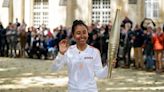Refugee Olympic Team cyclist carries the Olympic flame