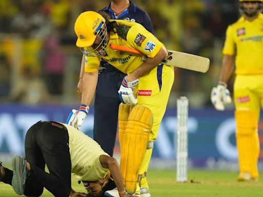 Watch: MS Dhoni comes to pitch invader's rescue for touching his feet