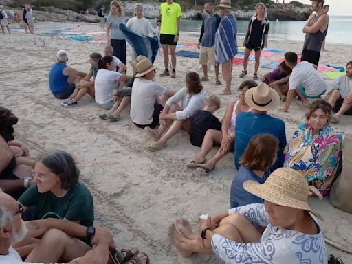 Protesters block beach in Spain spelling out message for tourists in sand