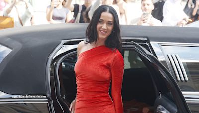 Katy Perry rocks red dress featuring lyrics from her new song 'Woman's World'