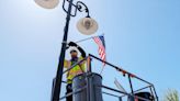 City hangs flags, dedicates downtown bench to veterans