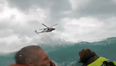 Dramatic video shows US Coast Guard rescue a man and his dog after their boat started sinking during Hurricane Helene