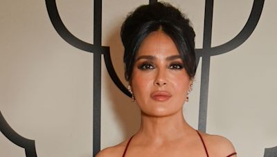 Salma Hayek Layered Sheer Snakeskin Cover-Up Over a Plunging One-Piece