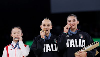 Chinese gymnast’s ‘relatable’ reaction to competitors biting medals on Olympic podium goes viral