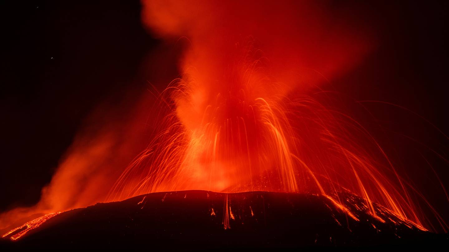 Photos show Mount Etna spewing hot lava into the air as Italian volcano erupts again