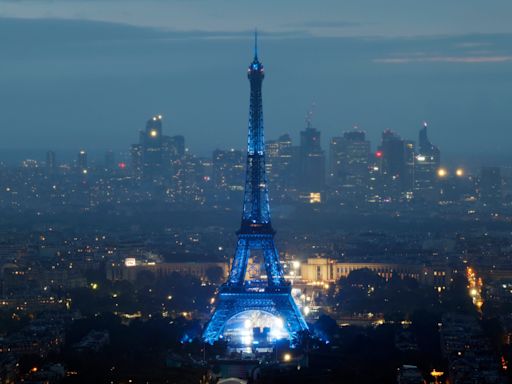 Eiffel Tower glows on rainy night, but many fans can't see opening ceremony