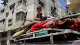 Gaza fighting intensifies, Israel asks why armed men were at UN site