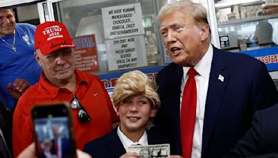 Trump superfan in suit and wig bursts into tears as he meets his idol