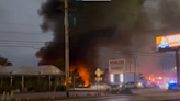 Fiery crash kills pilot and passenger when plane hits car dealership, Ohio cops say