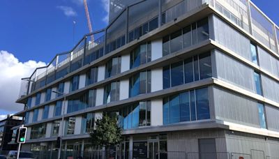 Why the opening of a posh new building on the site of Swansea's old Oceana nightclub has been delayed