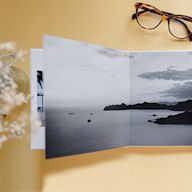 Layflat photo books are designed to lay flat when opened, allowing for seamless panoramic spreads. They are printed on high-quality paper and bound in a hardcover, making them durable and long-lasting. Layflat photo books are popular for wedding albums, family photo albums, and other special occasions.
