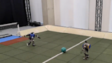 Watch two tiny, AI-powered robots play soccer