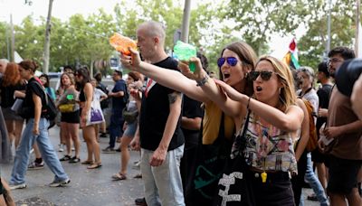 Furious anti-tourist protesters blast foreigners with WATER PISTOLS