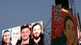 A billboard depicting Andrey Kozlov, at right, and the three other Israeli hostages, hangs in Tel Aviv after their rescue from Gaza by Israeli forces