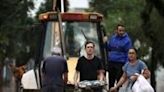 A construction vehicle carries evacuees from a flooded area of the Sao Geraldo neighborhood in Porto Alegre, on May 4, 2024