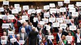Macron survives no-confidence vote but strikes and protests to continue across France
