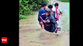 Teacher braves flooded stream, shifts kids to safety in Asifabad | Hyderabad News - Times of India