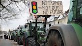 Protesting farmers use tractors – and piles of dung – to paralyse Germany