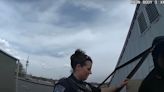 Moment police confront woman living in grocery store roof sign