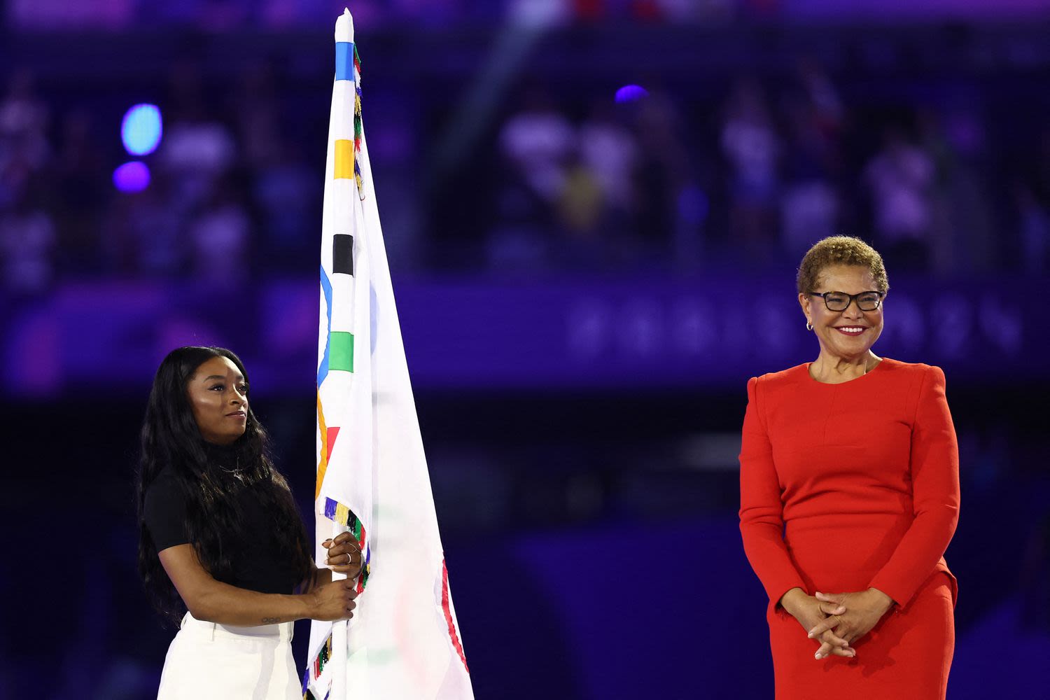 Simone Biles Carries the Olympic Flag During Paris Closing Ceremony as Olympics Transition to Los Angeles