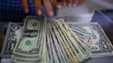 US dollar inches lower ahead of inflation report