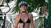 Kate Hudson shows off her tanned figure in a bikini top and shorts