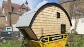 I turned a dumpster into a 25-square-foot tiny home in London for $4,800. My toilet is outside, but I love living here.