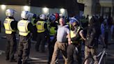 As an English town reels from the killing of 3 children, police face violent far-right protests