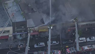 Large fire in the Bronx engulfs row of stores