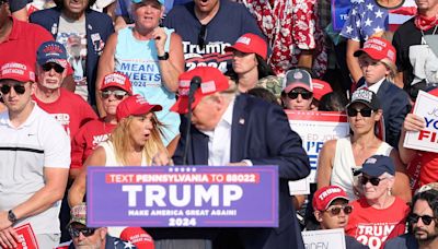 Woman sitting behind Trump at rally goes viral for strange behavior
